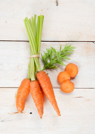 Fresh washed carrots on white wooden tableの写真素材