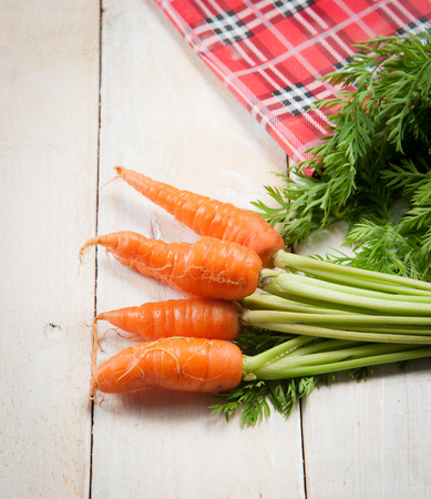 Fresh washed carrots on white wooden tableの写真素材