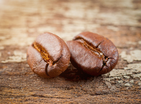 coffee grains on grunge wooden backgroundの写真素材