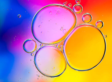 Background of colorful oil drops in waterの写真素材
