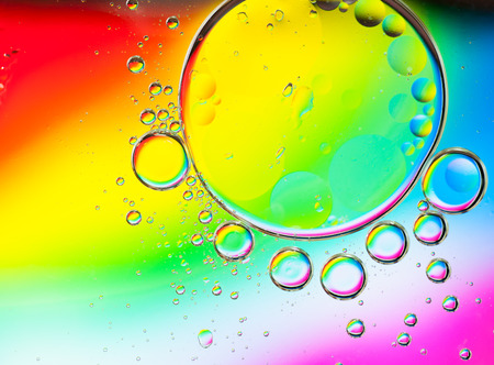 Background of colorful oil drops in waterの写真素材