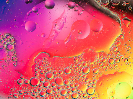 Background of colorful oil drops in waterの写真素材