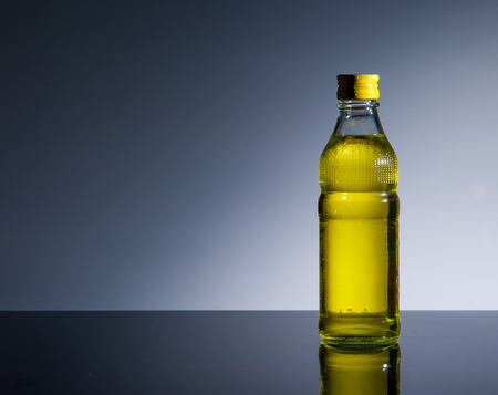 Bottle of yellow cocktail on glass ,dark backgroundの写真素材