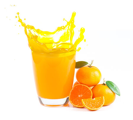 splashing orange juice with oranges against white の写真素材