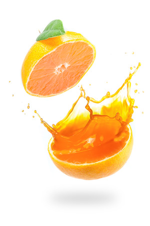 Orange juice splashing isolated on whiteの写真素材