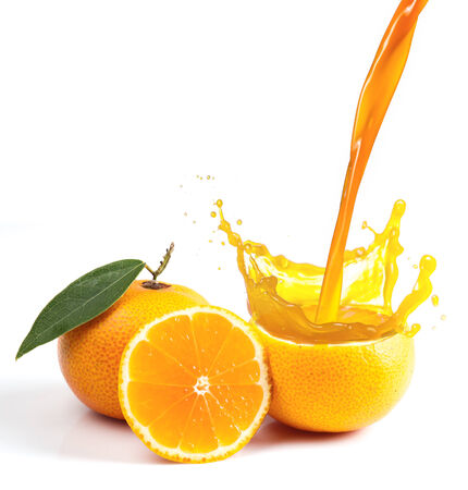 Orange juice splashing isolated on whiteの写真素材