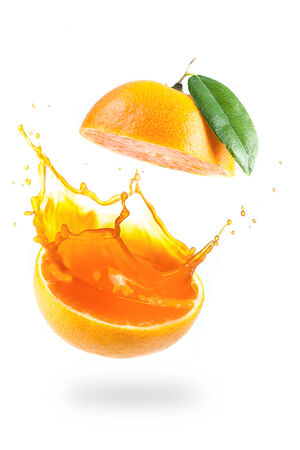 Orange juice splashing isolated on whiteの写真素材