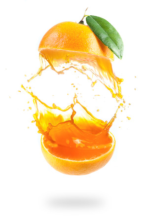 Orange juice splashing isolated on whiteの写真素材