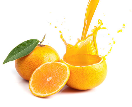 Orange juice splashing isolated on whiteの写真素材