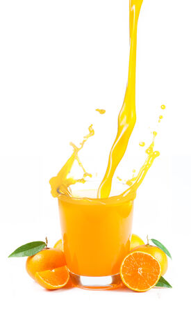 splashing orange juice with oranges against white backgroundの写真素材