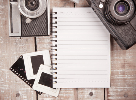 Old camera and film with diary on a wooden,vintage color toned imageの写真素材