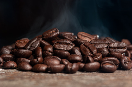 Coffee beans roasting with smokeの写真素材