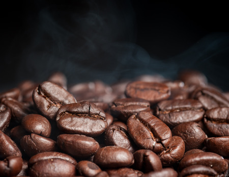 Coffee beans roasting with smokeの写真素材