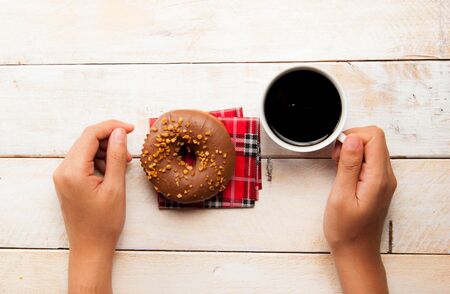 donuts and coffee on the wood backgroundの写真素材