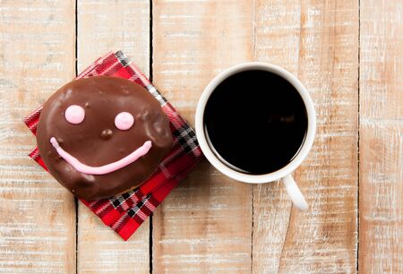 donuts and coffee on the wood backgroundの写真素材