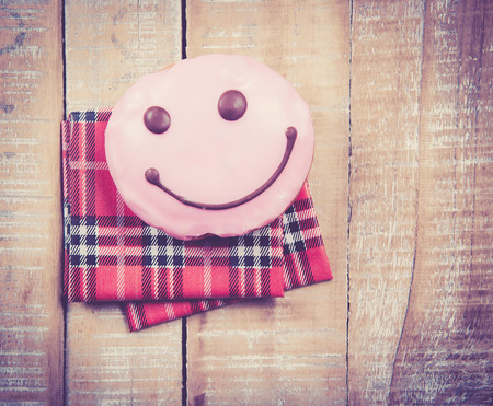 Sweet donut for a great morning breakfast on wood,vintage color toned imageの写真素材