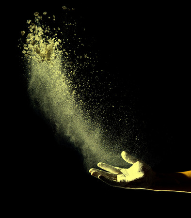 Hand and powder, isolated on black backgroundの写真素材