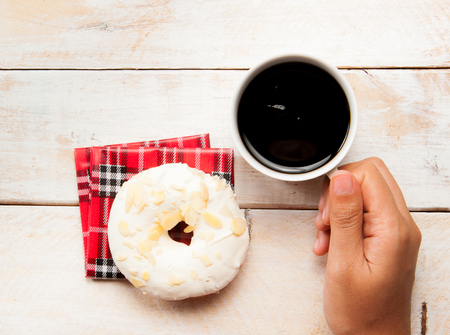 donuts and coffee on the wood backgroundの写真素材
