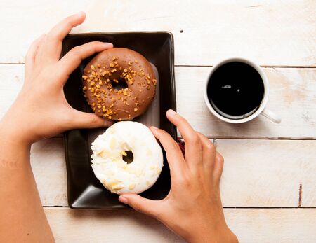 donuts and coffee on the wood backgroundの写真素材