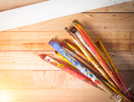 Used artist paintbrushes on wood backgroundの写真素材