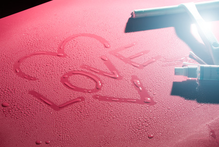Valentine Day Love heart made by water bubbles on a red backgroundの写真素材