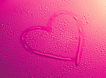 Valentine Day Love heart made by water bubbles on a red backgroundの写真素材