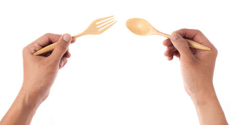 Man holding a wooden spoon, isolated on whiteの写真素材