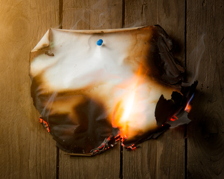 Fire paper on wooden backgroundの写真素材