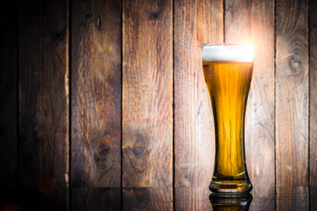 Glass beer on wood background with copyspaceの写真素材