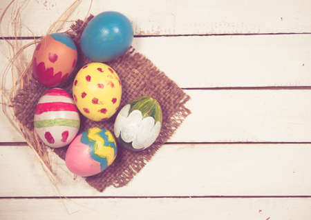 Easter eggs on wooden background,vintage color toned imageの写真素材