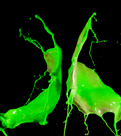 splashes of green paint isolated on black background