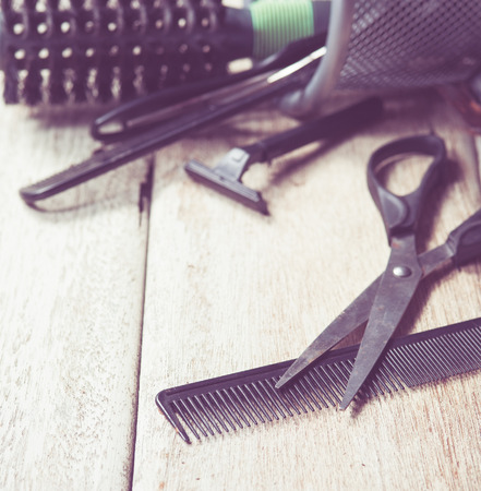 hairdresser tools on white wood,vintage color toned imageの写真素材