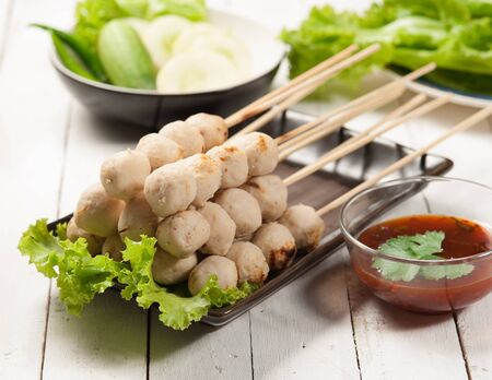 Grilled meat balls with sweet spicy sauce and vegetablesの写真素材