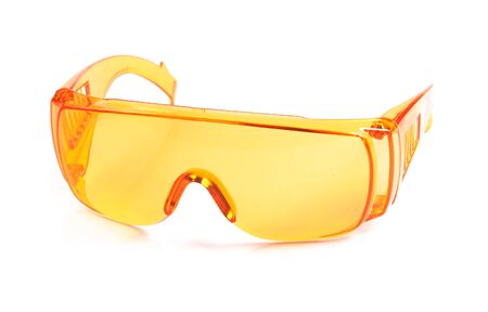 orange safety glasses isolated on whiteの写真素材