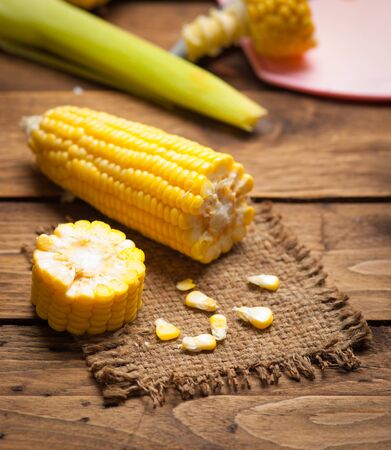 Fresh sweet corn on wooden table. Selective focus.の写真素材