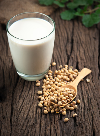 Soy milk with beans on woodの写真素材