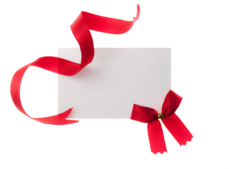 Shiny red ribbon with card isolated on whiteの写真素材