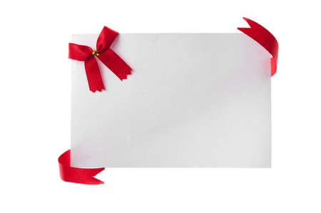 Shiny red ribbon with card isolated on whiteの写真素材