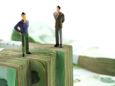 Miniature businessman on banknotesの写真素材