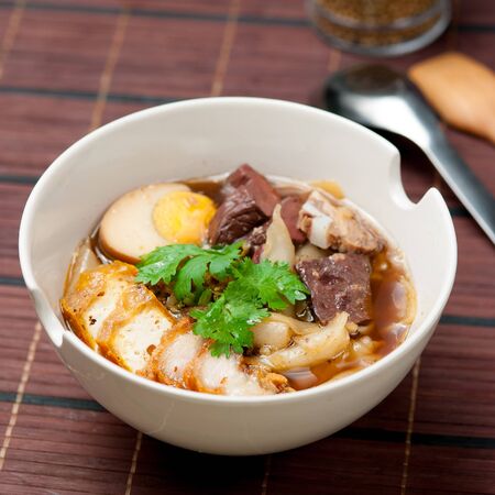 egg pork paste of rice flour, boiled Chinese pasta square on table