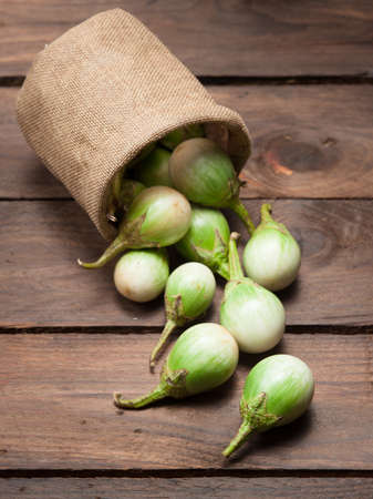 Ripe eggplant on a wooden table.の写真素材