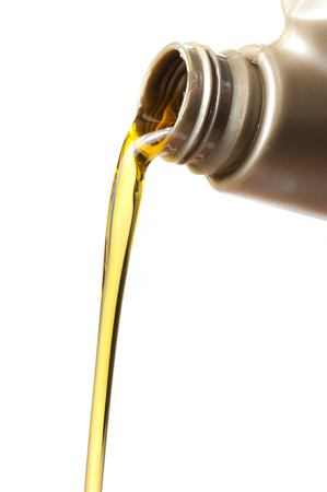 pouring engine oil from its plastic container on white background,Selective focusの写真素材