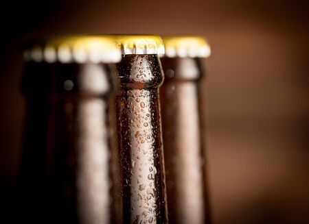 Close up Bottle of beer with drops on dark backgroundの写真素材