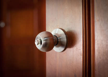 door handle keyhole with old design on brown wood doorの写真素材