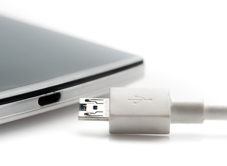Smartphone with charger on white background,USB cable