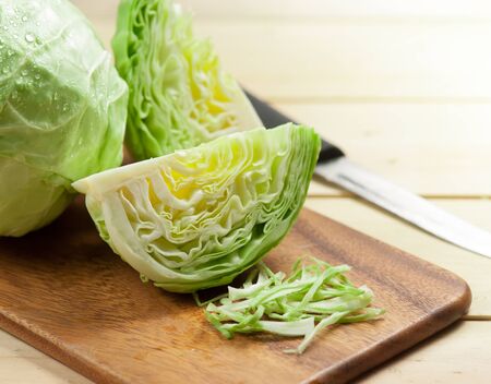 cabbage and cutted cabbage on woodenの写真素材