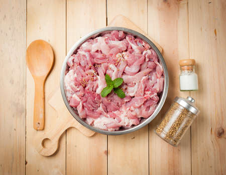 fresh raw pork with spices on cutting boardの写真素材