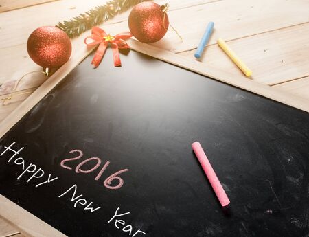 Happy New Year 2016-chalk text with Christmas balls on blackboard,new year concept