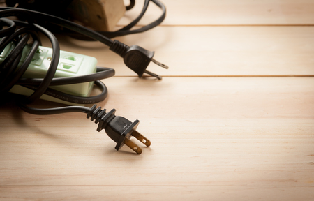 Electric extension strip on woodの写真素材