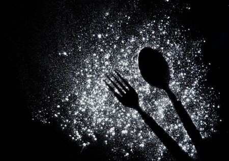 Imprint fork and spoon made of flour on a blackの写真素材